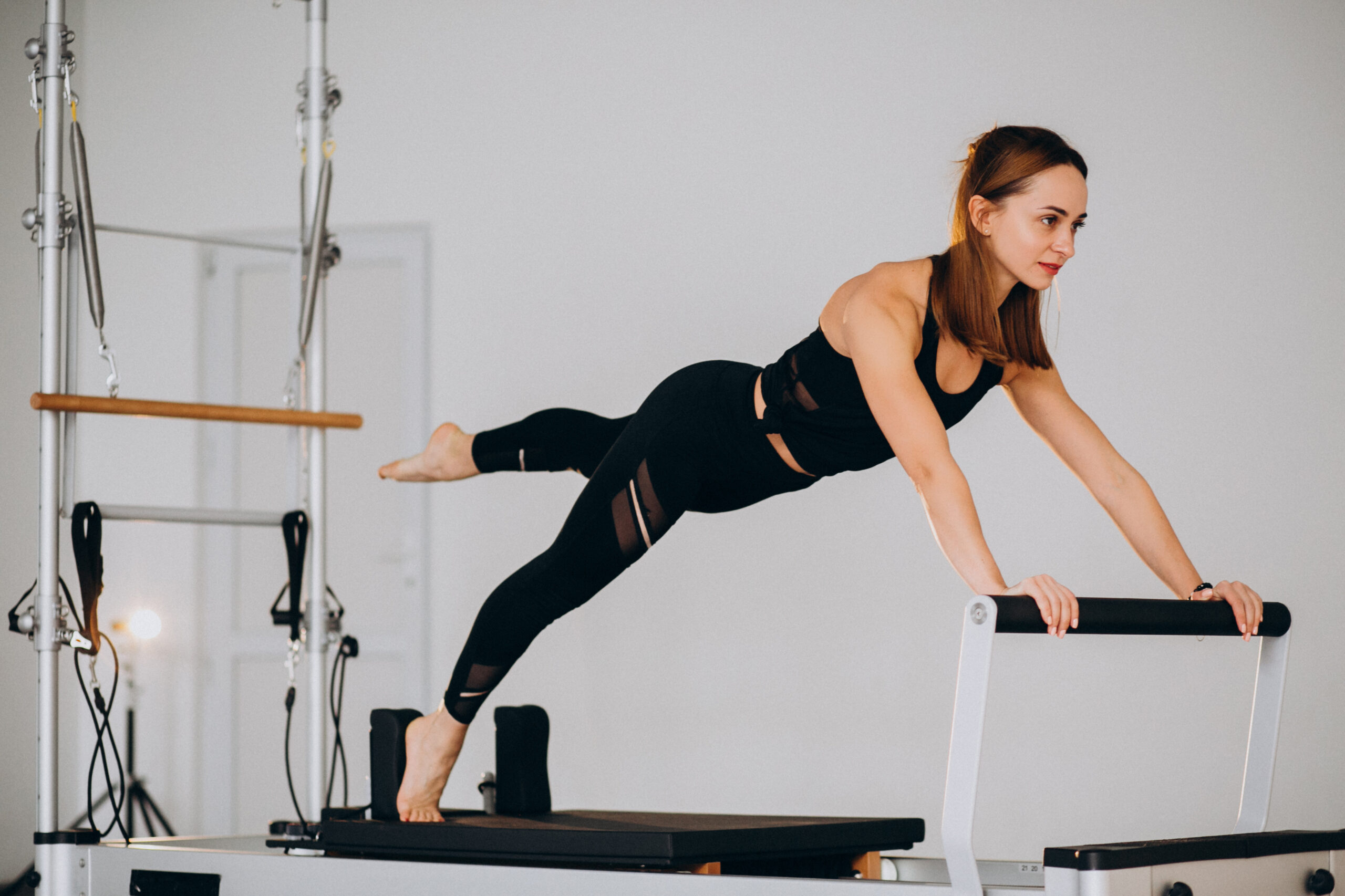 woman using reformer pilates